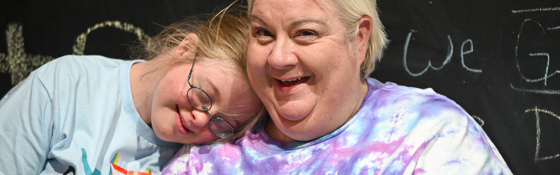 girl resting her head on a woman